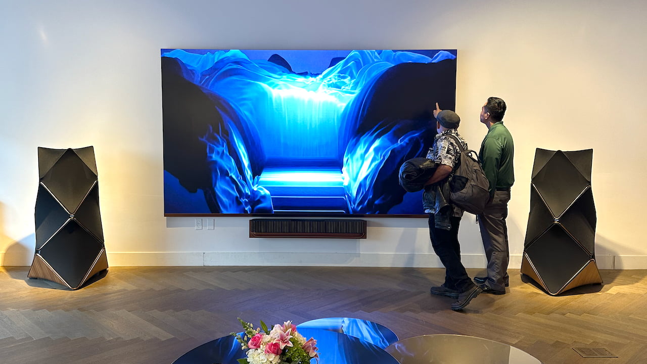 People pointing at LG MAGNIT 136-inch TV with Bang & Olufsen Beolab 90 loudspeakers in Costa Mesa, CA