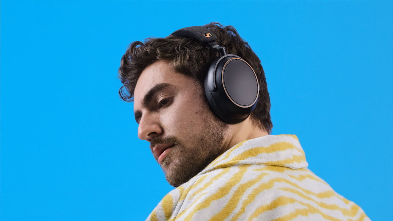 Man wearing new Black Copper edition Sennheiser Momentum 4 Wireless Headphones